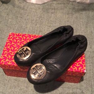 Tory Burch black ballet flat with gold “T”s.